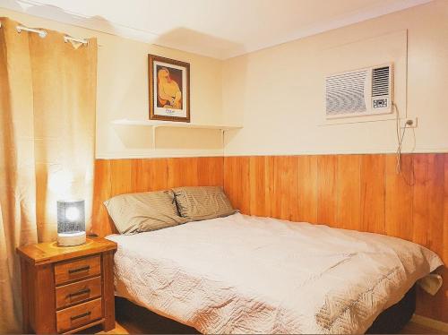 a bedroom with a bed and a table with a night stand at Main Reef Hotel in Boulder