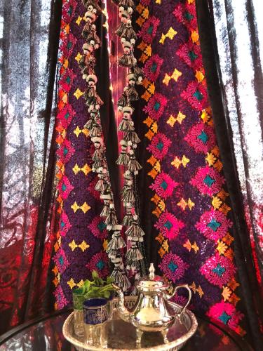 a close up of a table with a tea kettle and ties at Riad Ibn Battouta & Spa in Fès