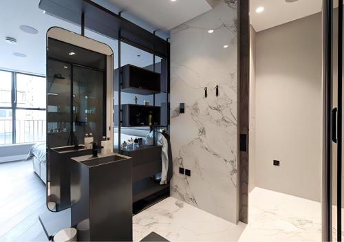 a bathroom with a sink and a mirror at StayLux Soho in London