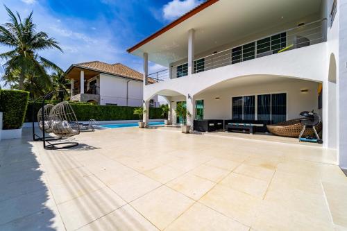 a patio in the backyard of a house at Modern 4 Bedroom Pool Villa in Good Location VY in Hua Hin