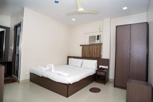 a bedroom with a bed with two towels on it at Sonar Bangla Guest House in Kolkata