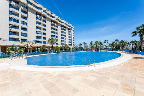 a large swimming pool in front of a building at RESORT BEACH VALENCIA in Valencia