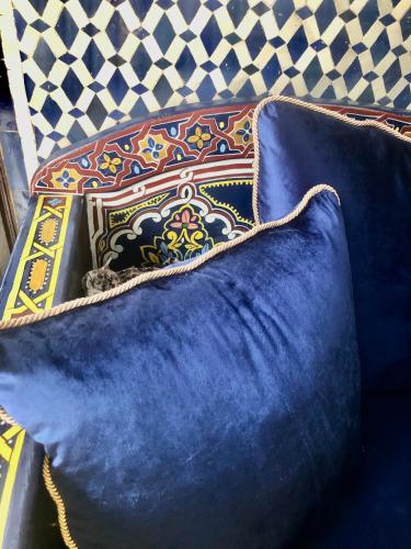 a group of pillows sitting on top of a couch at Riad Ibn Battouta & Spa in Fès