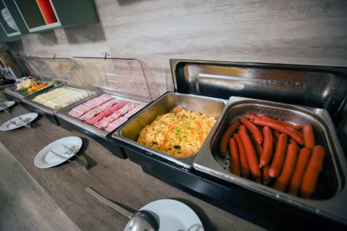 a buffet with a tray of food and carrots at Hotel Barborka in Přední Výtoň