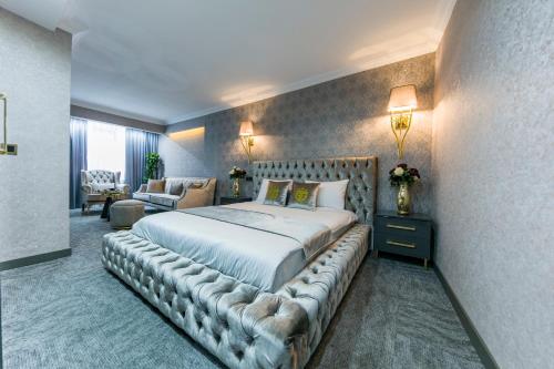 a bedroom with a large bed with a leather tufted headboard at Grand Gedikpasha Hotel in Istanbul