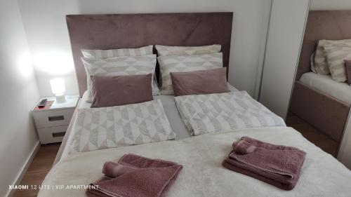a bedroom with two beds with towels on them at VIP Apartment in Jagodina