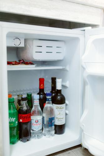 an open refrigerator filled with bottles of alcohol at Opera Avenue Hotel in Yerevan