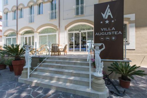 a sign in front of a building with stairs at Hotel Villa Augustea in Rimini