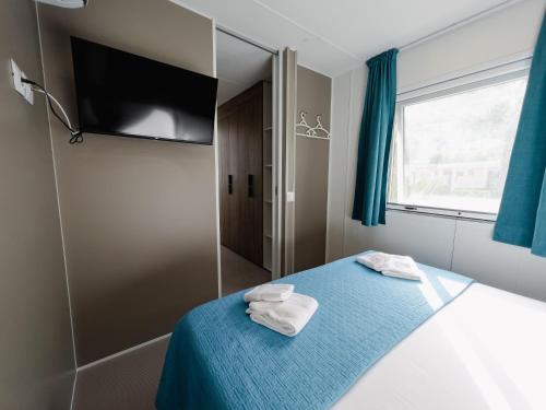 a bedroom with a bed with two towels on it at Le Palme Village in Terracina