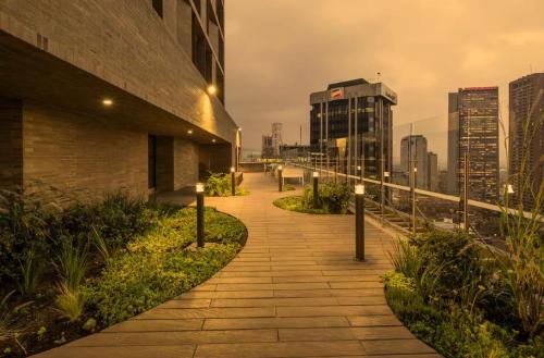 a walkway in the middle of a city with buildings at Loft estilo Japonés in Bogotá