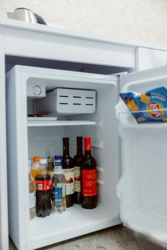 an open refrigerator filled with lots of drinks at Opera Avenue Hotel in Yerevan