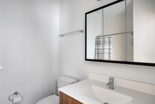 a bathroom with a sink and a mirror at Central Sq 2br w Doorman nr Charles River BOS-951 in Cambridge