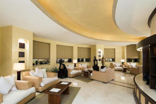 a large living room with couches and tables at Villa del Palmar Beach Resort & Spa in Cabo San Lucas