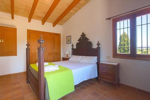 a bedroom with a bed and a dresser and window at Villa Cifre in Alcudia