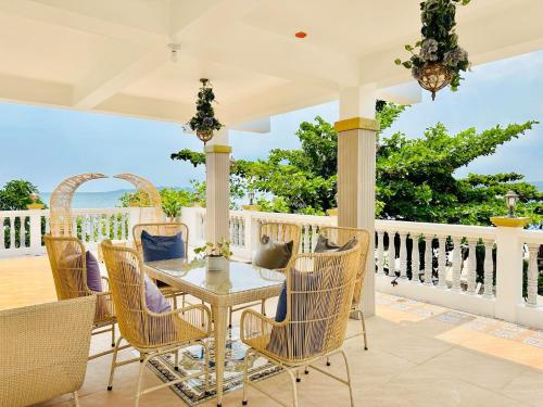 a patio with a table and chairs on a balcony at The Kroun Seafront Residences 