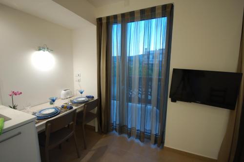 a room with a table and a large window at Resort Sitges Apartment in Sitges