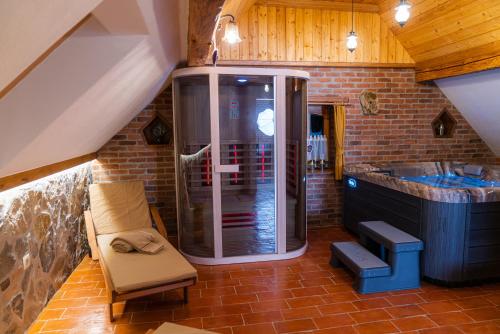 a bathroom with a shower and a bench in a room at Guesthouse Močivnik in Okroglice