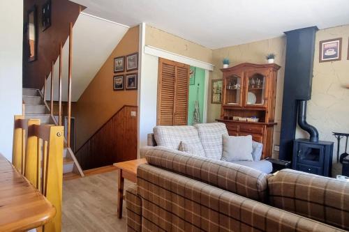 a living room with a couch and a stove at Family Place, Next to Ski Lift & Mountain view! in Alp