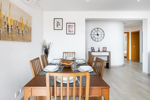 uma sala de jantar com uma mesa de madeira e cadeiras em Vilamoura - Spacious with Swimming Pool & View em Vilamoura