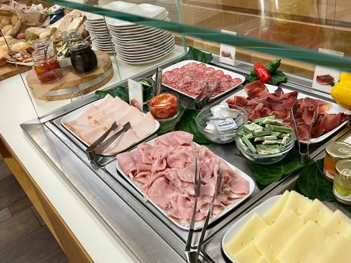 a buffet filled with different types of meats and cheese at Hotel Miramonti in Schio