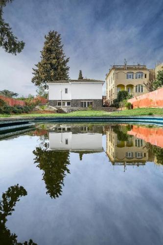 a reflection of a building in a body of water at Casa Maui in Banyoles