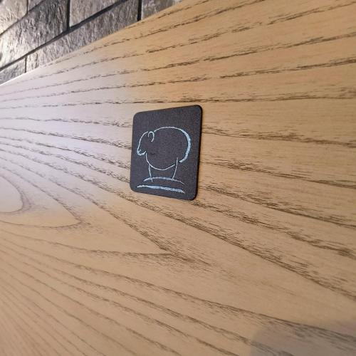 a sticker of a dog on top of a wooden table at Hotel Miramonti in Schio