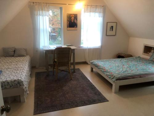 a bedroom with a table and a bed and a desk at Rast und Ruhe in Wechingen