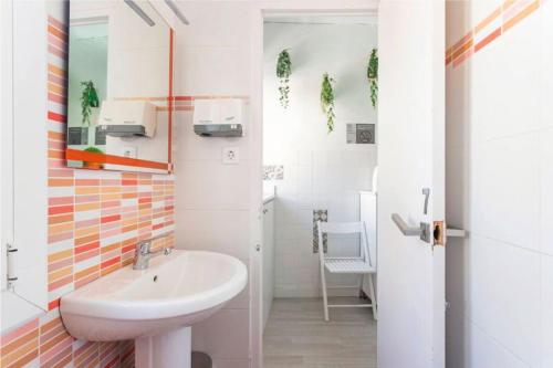 a white bathroom with a sink and a toilet at Wood&Stone Rooms - Eywa Hogar in Yecla