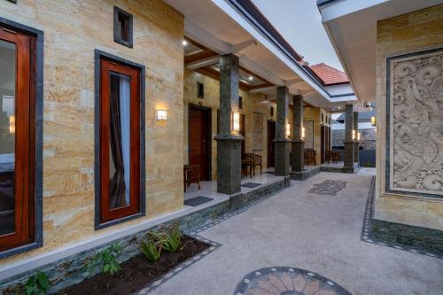 an empty walkway in a building with columns at Pratiwi House Lembongan in Nusa Lembongan