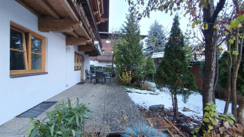 a courtyard of a house with snow on the ground at Haus Monika in Kirchberg in Tirol