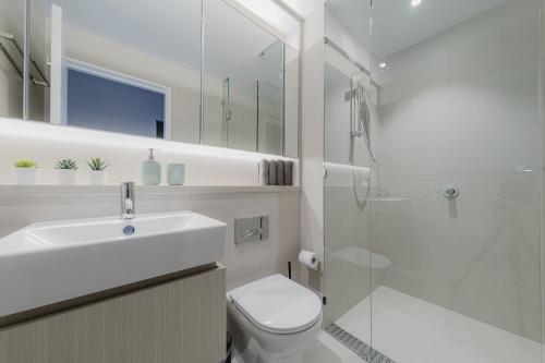 ein Bad mit einem Waschbecken, einem WC und einer Dusche in der Unterkunft Modern 2 Bedroom Apartment Darling Square in Sydney