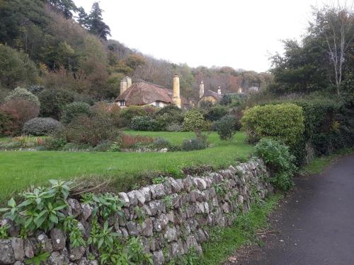 a stone retaining wall next to a road at Montrose Guest House in Minehead