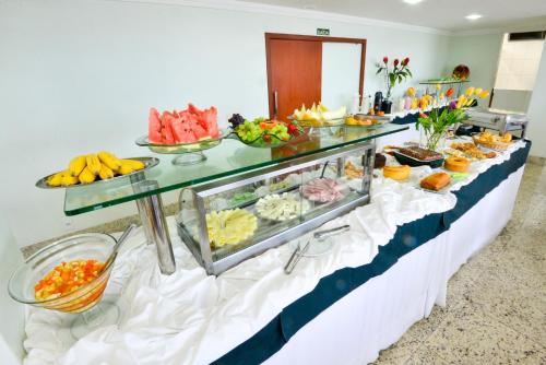 a buffet line with many different types of food at Hotel Plaza Mar in Vila Velha