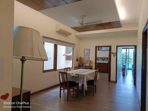 a kitchen and dining room with a table and chairs at Pristine home near New Friends colony in New Delhi