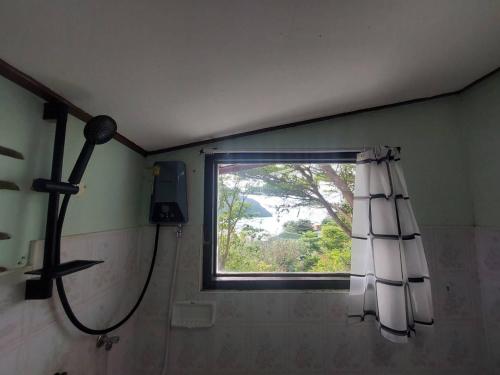 a shower in a bathroom with a window at Phi Phi View Point Resort in Phi Phi Islands