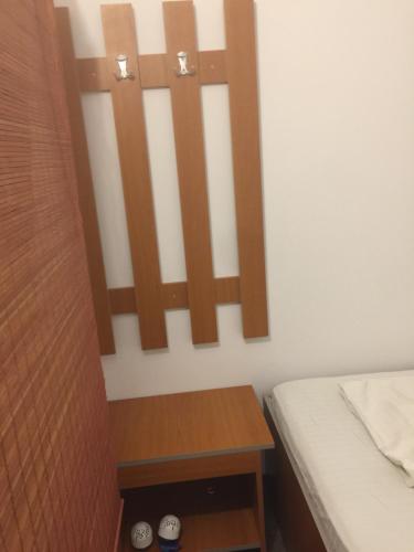 a small bedroom with a bed and a wooden cabinet at Rafting & Via Ferrata Base Camp in Vadul lui Carol II