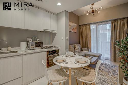 a kitchen and dining room with a table and chairs at Mira Holiday Homes - Lovely 1 bedroom in Business Bay in Dubai