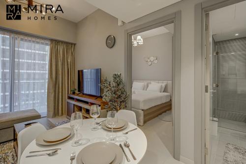 a living room with a dining table and a bedroom at Mira Holiday Homes - Lovely 1 bedroom in Business Bay in Dubai