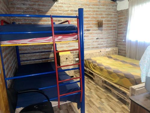 a bunk bed room with two bunk beds and a ladder at Casa de Campo en Zuleta in Huamboya