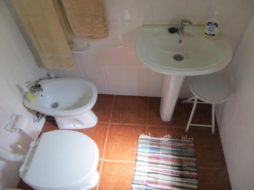 a small bathroom with a toilet and a sink at Dream House On The Beach in Figueira da Foz