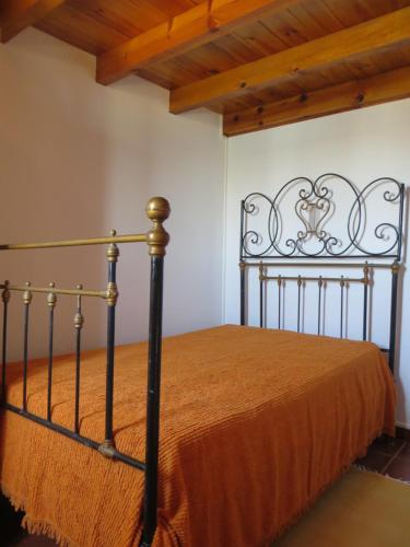 a bedroom with a bed with an orange bedspread at Dream House On The Beach in Figueira da Foz
