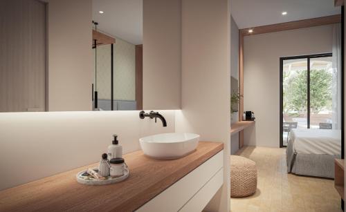 a bathroom with a sink on a counter at Nikon Boutique Hotel in Kalamaki