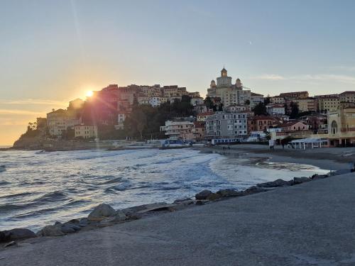 a view of a beach with buildings and the ocean at THE SHELL - New interior look but same old charme 200 mt from the sea with garden and parking nearby in Imperia