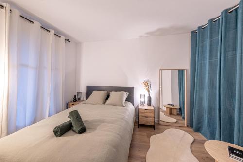 een slaapkamer met een groot bed en blauwe gordijnen bij Cosy Corner Disney in Bailly-Romainvilliers