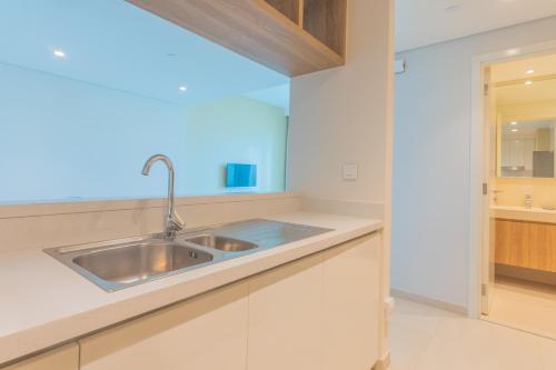 a kitchen with a sink and white cabinets at Bellavista Apartments Holiday Homes LLC - Downtown Views II T1 - 2 Bedroom Apartment with Burj Khalifa View in Dubai