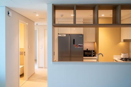 a kitchen with a stainless steel refrigerator at Bellavista Apartments Holiday Homes LLC - Downtown Views II T1 - 2 Bedroom Apartment with Burj Khalifa View in Dubai