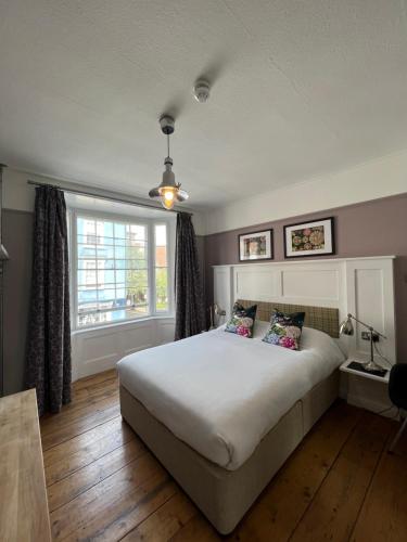 a bedroom with a large bed and a window at White Horse in Maldon
