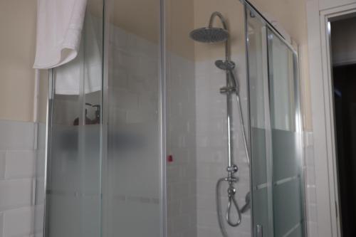 a shower in a bathroom with a glass door at B&B La Casetta in Cambiago
