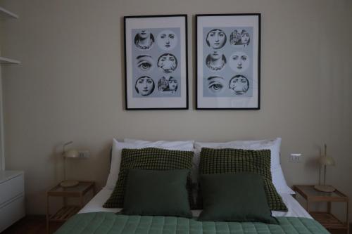 a bedroom with three pictures above a bed at B&B La Casetta in Cambiago