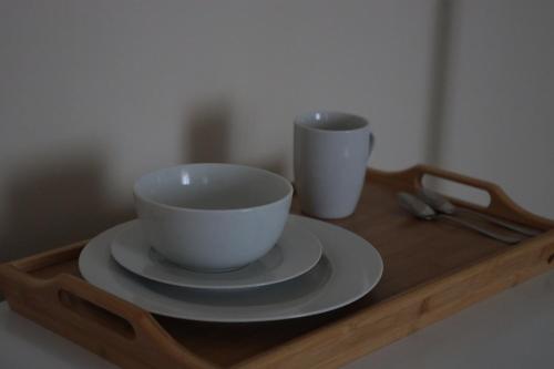 a wooden tray with two cups on top of it at B&B La Casetta in Cambiago